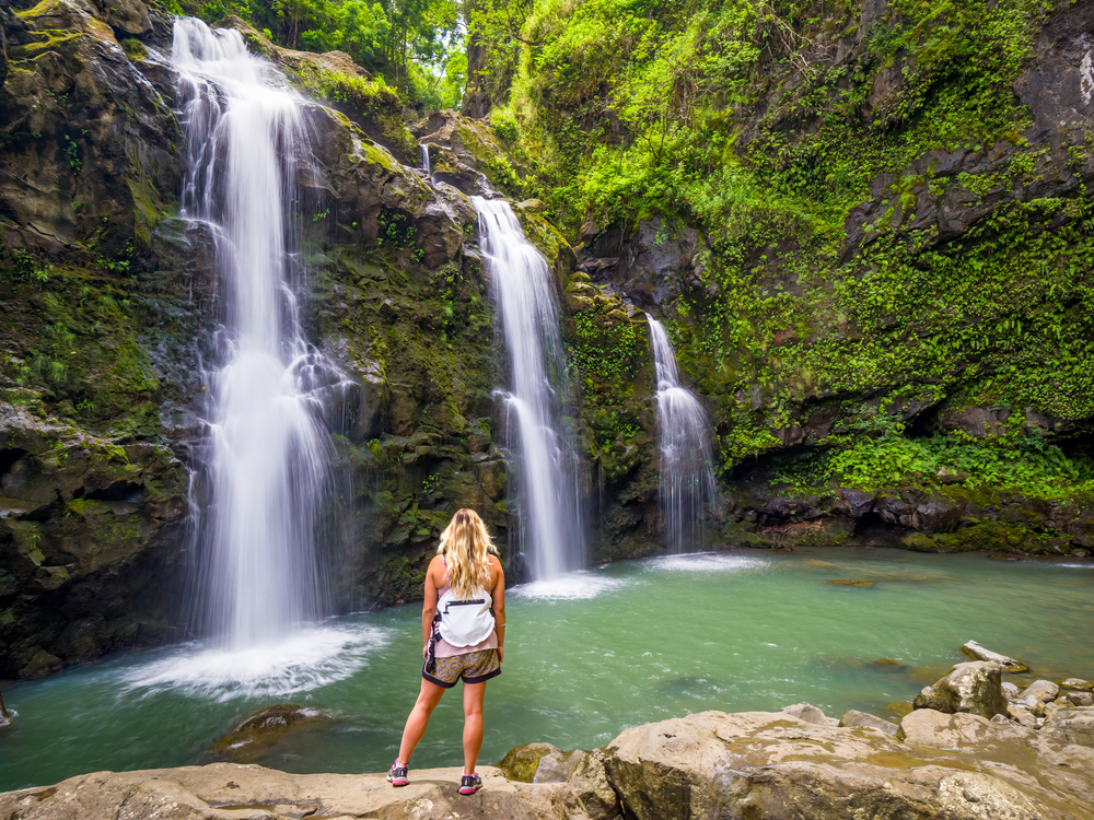Woman hiking to Upper Waikani Falls