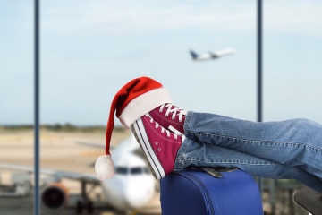 boy with santa hat in airport