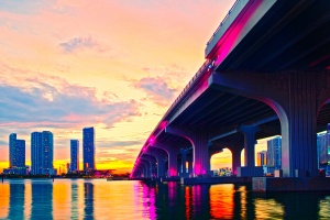 Miami Florida at sunset, colorful skyline of illuminated buildings and Macarthur causeway bridge