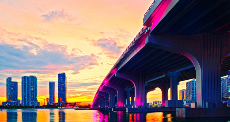 Miami Florida at sunset, colorful skyline of illuminated buildings and Macarthur causeway bridge