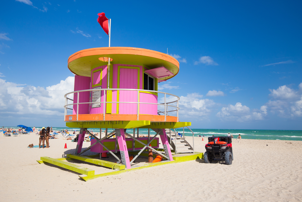 Lifeguard tower in a colorful Art Deco style, with blue sky and Atlantic Ocean in the background. World famous travel location. Miami beach, South Beach, Florida