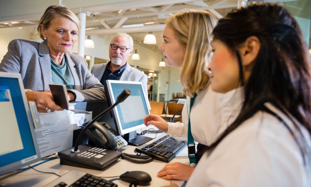 flight desk attendant helping customer find cheap first class flights