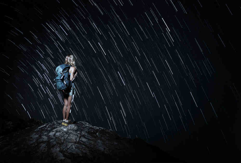 Stargazer and Star Trails / Shutterstock