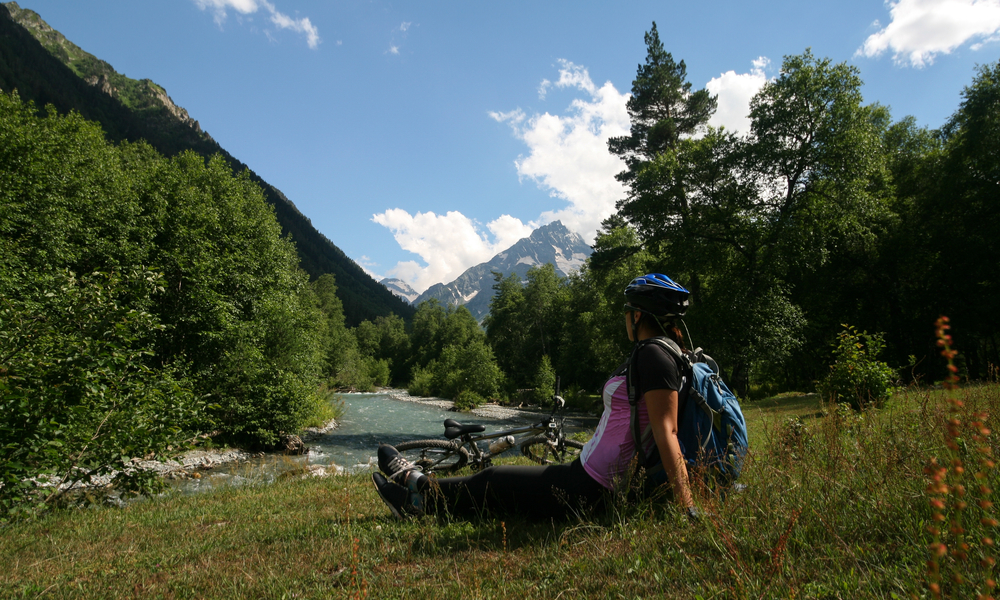 Cyclist admires the mountains of Arkhyz, Russia