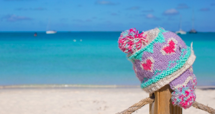 Closeup warm knitted cap on fence at tropical beach