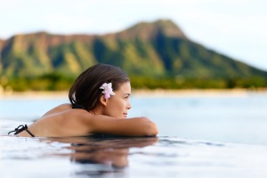 woman overlooking island infinity pool