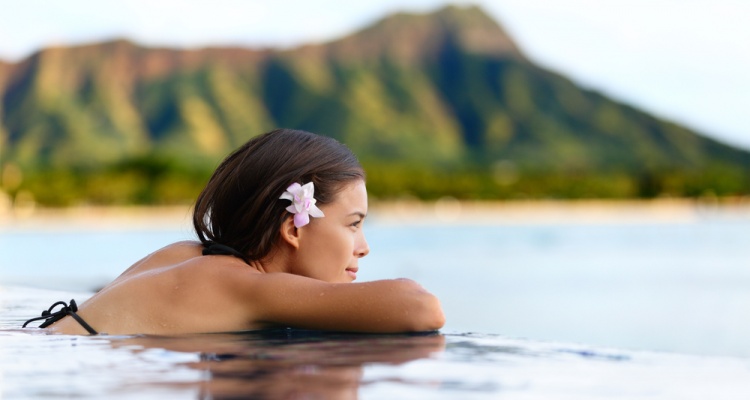 woman overlooking island infinity pool