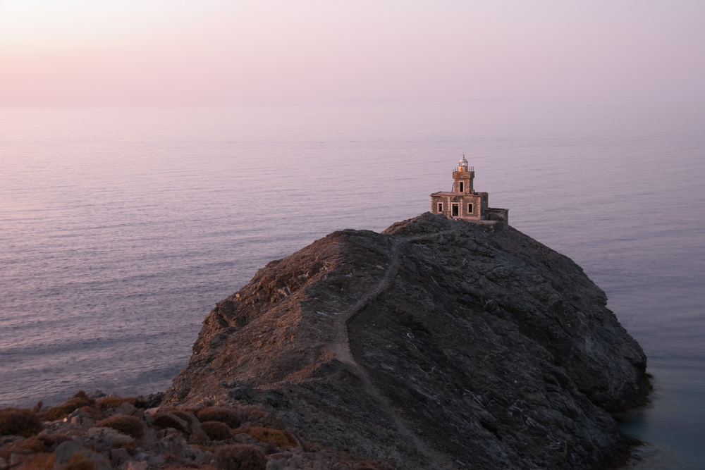 A stone lighthouse at dusk