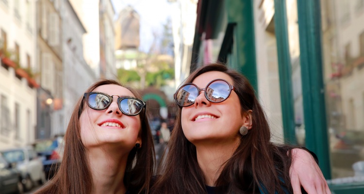 Happy beautiful student girls on the street