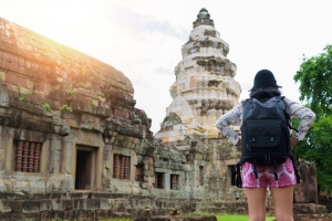 Asian woman backpacker solo travels outdoor lifestyle at ancient in Thailand