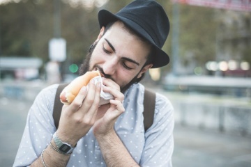 man eating a hotdog