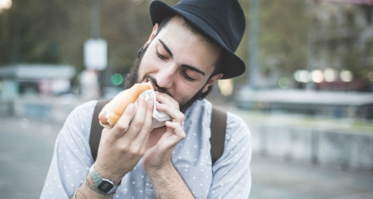 man eating a hotdog