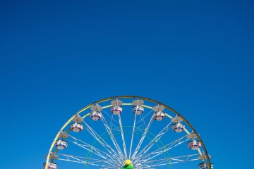 Carnival Ferris Wheel with Clean Skies with Empty Space Close up shot of half of a ferris wheel in Coachella California.