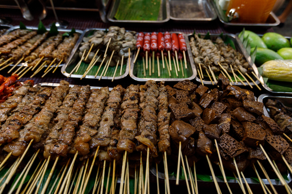 Barbecued pork and chicken at a food stall at Bonifacio night market in Manila, Philippines