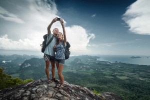 Couple taking seflie on mountain