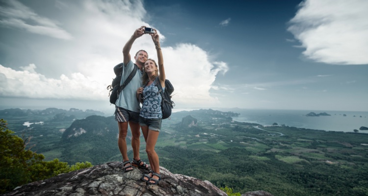 Couple taking seflie on mountain