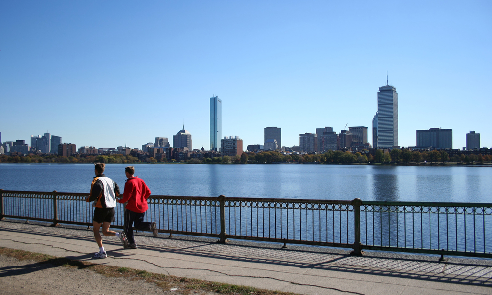 jogging by the Charles River with part of the boston Skyline