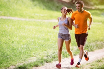 Couple jogging and running outdoors in nature