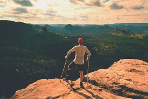 Tired tourist with crutches in hands.