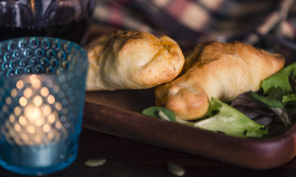 Food from Patagonia: Two lamb stuffed empanadas and a glass of local red wine in a chic retreat in the south of the world.