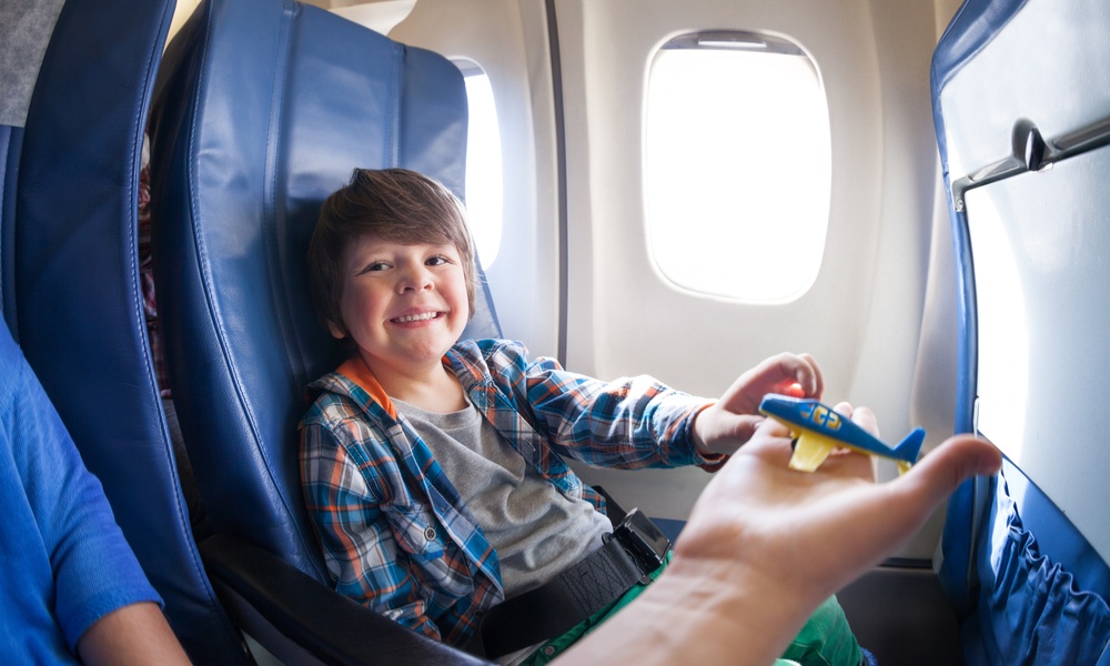 child relaxing on plane