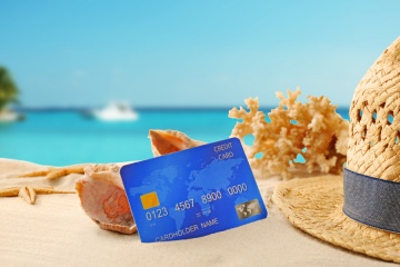 Credit card on holiday on blurred resort background