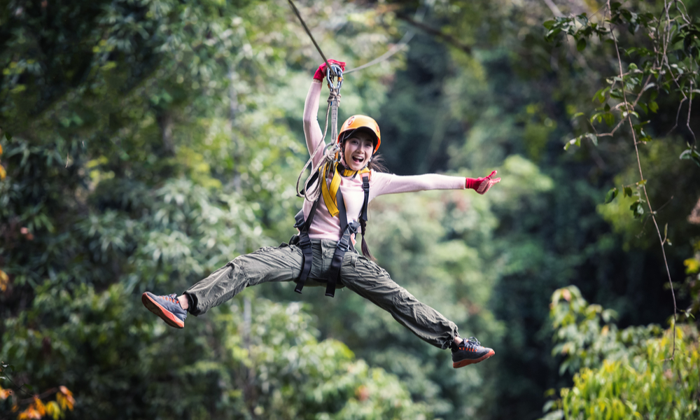 Woman Tourist Wearing Casual Clothing On Zip Line