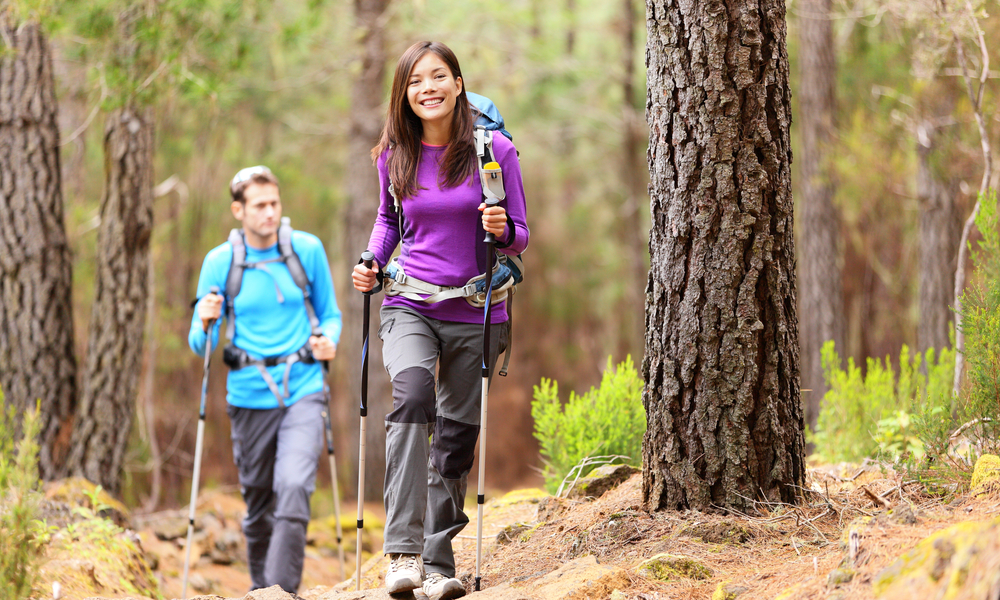 A happy couple hiking in the forest