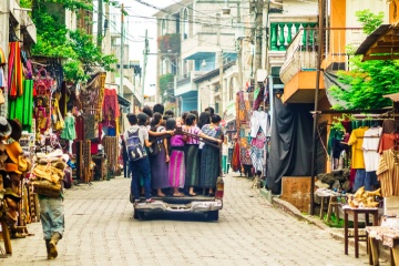 View on Group of indigenous Maya kids using public transpart by small village in Guatemala