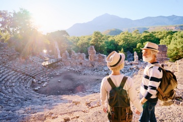 Senior family couple enjoying view together on ancient amphitheatre.