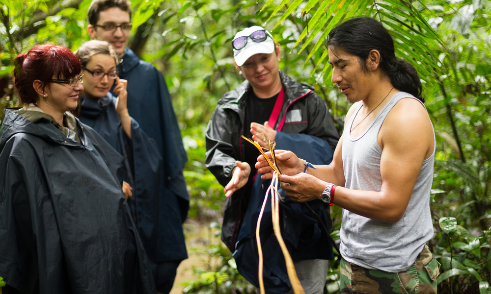 NATURALIST LOCAL GUIDE WITH GROUP OF TOURIST IN CUYABENO WILDLIFE RESERVE, ECUADOR