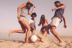 playing soccer on the beach