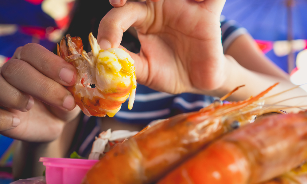 person eating shrimp