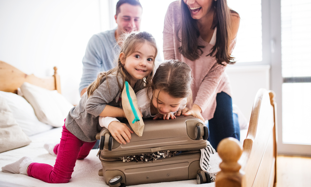 Young family with two children packing for holiday.