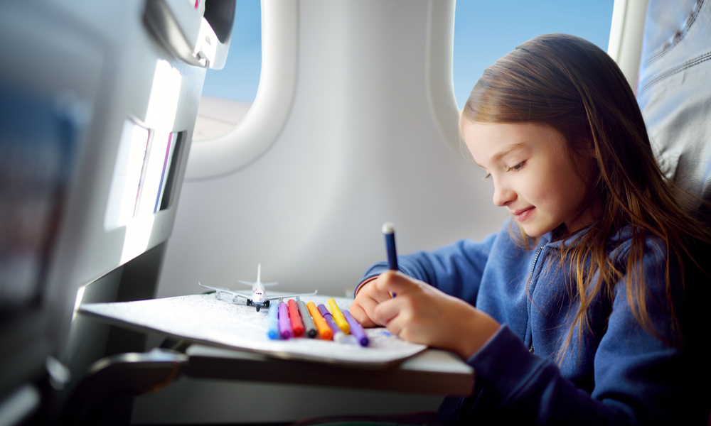 Adorable little girl traveling by an airplane