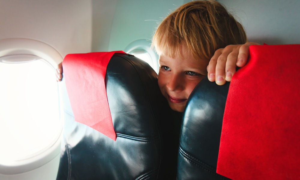 kids travel- cute little boy in plane