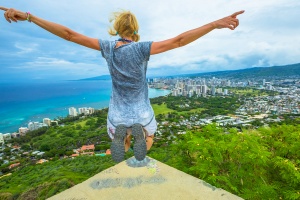 Happy hiker jumping. Hawaiian hiking by popular Diamond Head hike.