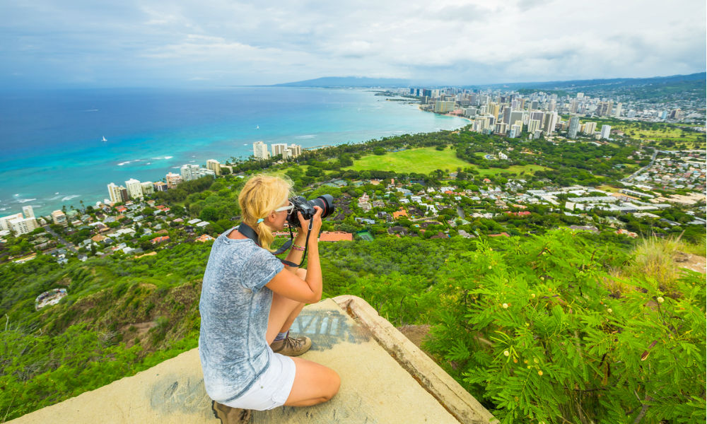 Travel photographer takes a shot of Honolulu and Waikiki beach, Oahu in Hawaii from Diamond Head State Monument. 