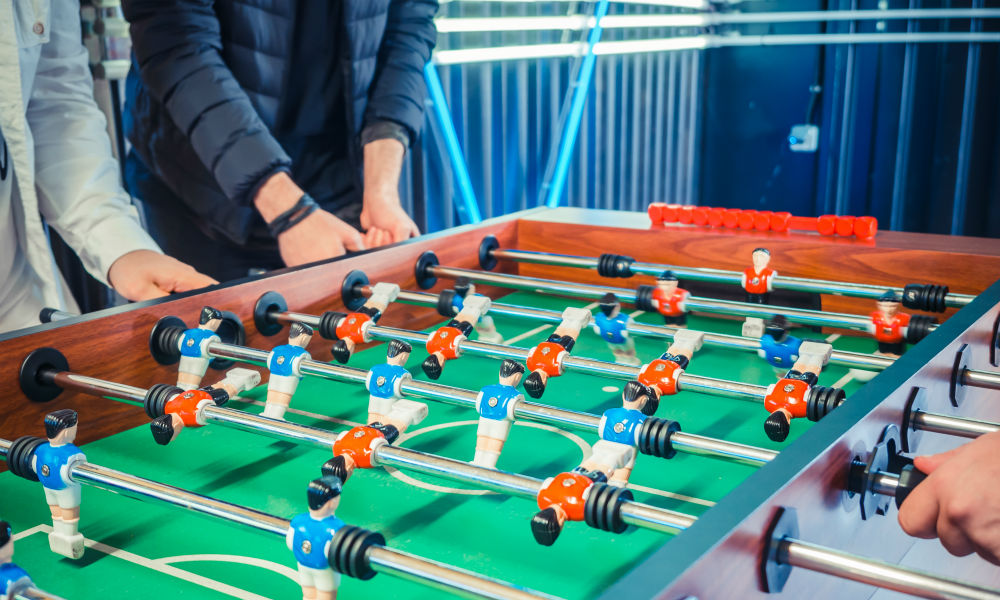  image of active people playing foosball