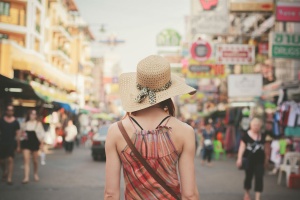 Rear view of a young woman walking the famous backpacker street Khao San in Bangkok, Thailand