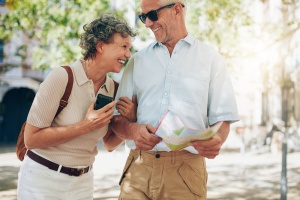 Smiling mature man and woman roaming around the city.