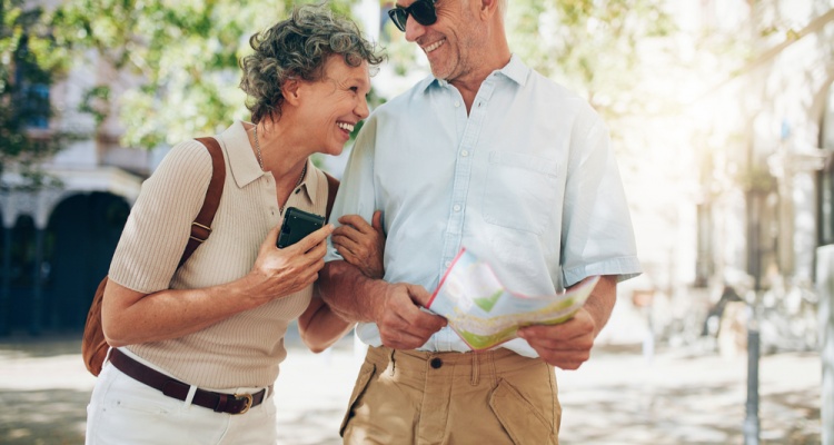 Smiling mature man and woman roaming around the city.