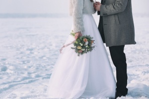 Happy wedding couple outdoors on winter day