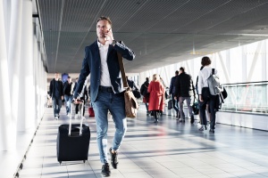 Busy man speaking on phone and walking in airport