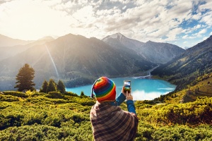 Tourist taking a photo of rainbow mountains in Peru