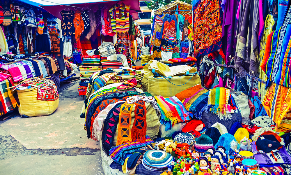 Colorful handmade handicrafts of different colors in indian market of Otavalo in Ecuador