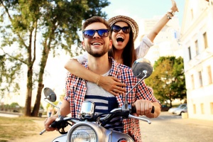 two happy travelers on a vespa