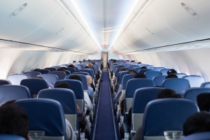 Passengers traveling by a plane, shot from the inside of an airplane