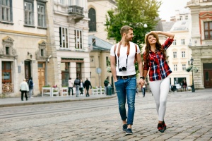 man and woman tourists holding hands