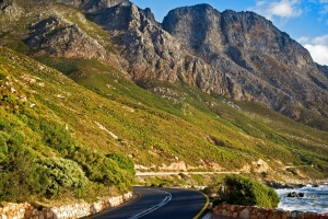 The green and rocky hilly slopes along the beautiful and scenic coastal road of the Garden Route, Cape Town, South Africa.